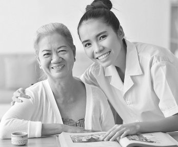 caregiver and senior woman smiling