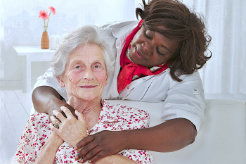 caregiver hugs the senior woman